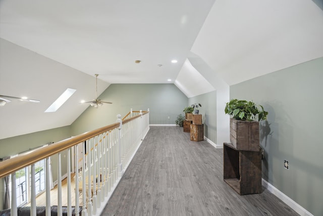 44 Emery Mills Rd, Lebanon, ME 04027 - corridor with a skylight, vaulted ceiling, wood finished floors, an upstairs landing, and baseboards