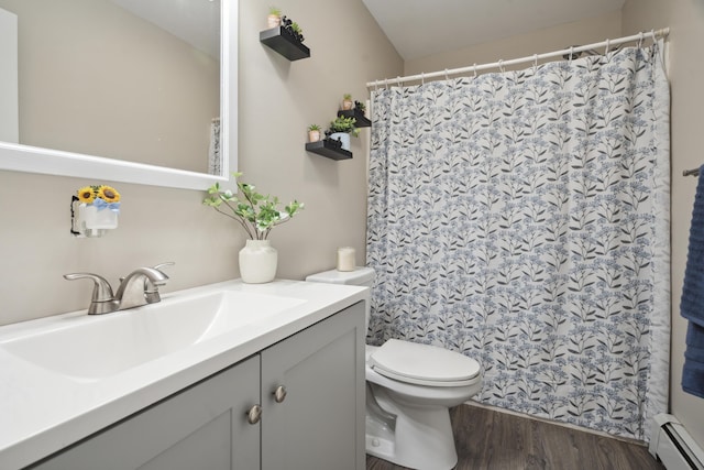 44 Emery Mills Rd, Lebanon, ME 04027 - full bath with a baseboard heating unit, vanity, toilet, wood finished floors, and a shower with curtain