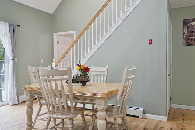 44 Emery Mills Rd, Lebanon, ME 04027 - dining area featuring light wood-type flooring, stairs, baseboards, lofted ceiling, and a baseboard radiator