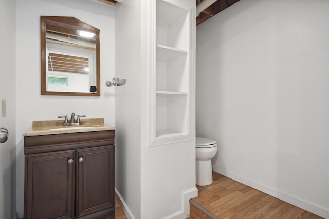 44 Emery Mills Rd, Lebanon, ME 04027 - bathroom featuring toilet, wood finished floors, vanity, and baseboards