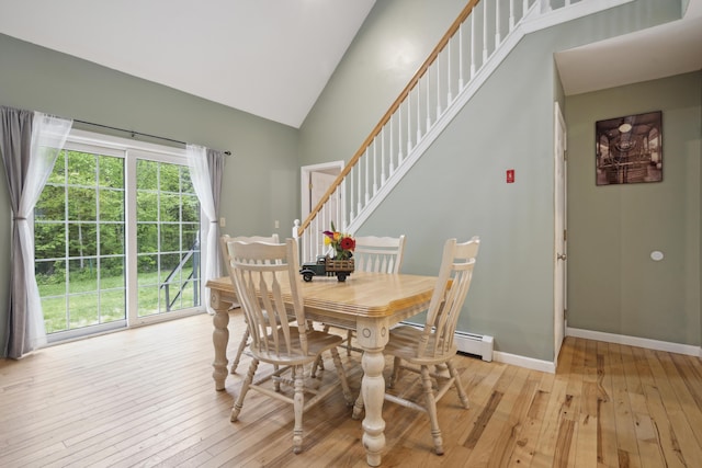 44 Emery Mills Rd, Lebanon, ME 04027 - dining area with light wood-style floors, high vaulted ceiling, baseboards, and stairs