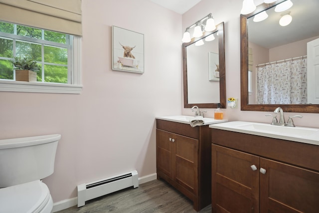 44 Emery Mills Rd, Lebanon, ME 04027 - full bath with a baseboard radiator, vanity, toilet, wood finished floors, and baseboards