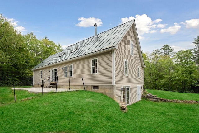 44 Emery Mills Rd, Lebanon, ME 04027 - rear view of house with a standing seam roof, a patio area, a yard, metal roof, and entry steps