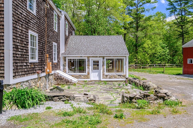 24 Cassella Dr, Jefferson, ME 04348 - view of front facade featuring roof with shingles and stone siding