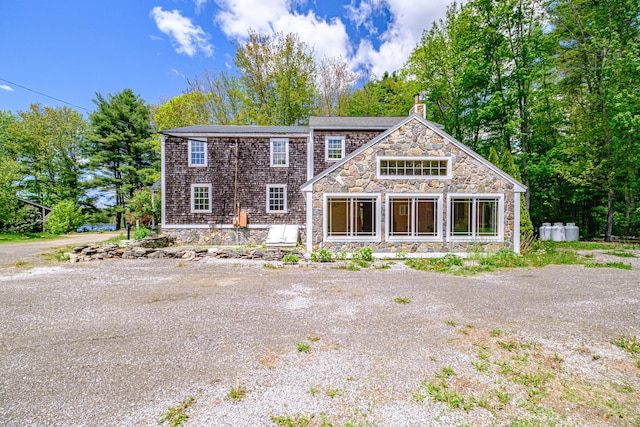 24 Cassella Dr, Jefferson, ME 04348 - view of front of house with stone siding and a chimney