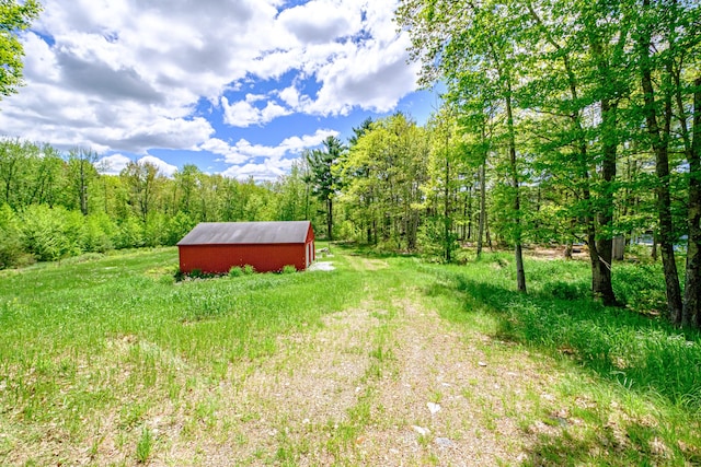 24 Cassella Dr, Jefferson, ME 04348 - view of yard featuring an outdoor structure and a view of trees