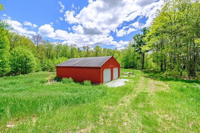 24 Cassella Dr, Jefferson, ME 04348 - view of yard with a detached garage, an outdoor structure, and a wooded view