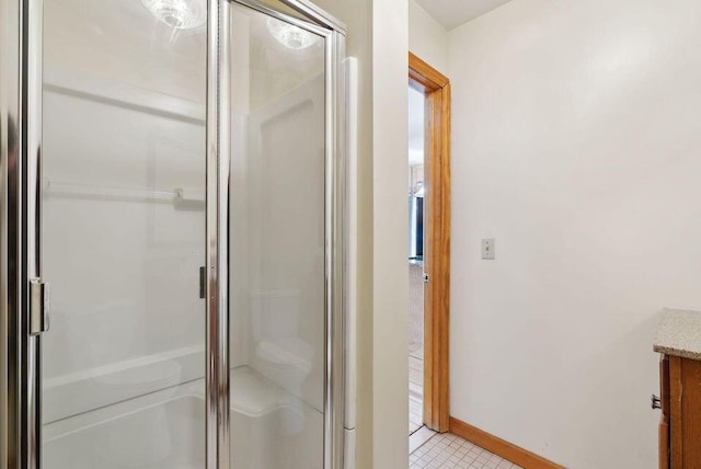 24 Cassella Dr, Jefferson, ME 04348 - bathroom featuring a stall shower, vanity, baseboards, and tile patterned floors