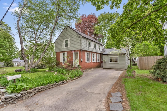 25 Church St, Gorham, ME 04038 - view of front of home with brick siding, driveway, and a chimney