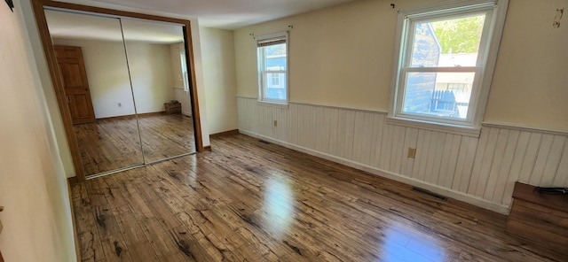 162 30th St, Shapleigh, ME 04076 - unfurnished bedroom with hardwood / wood-style floors, a wainscoted wall, and a closet