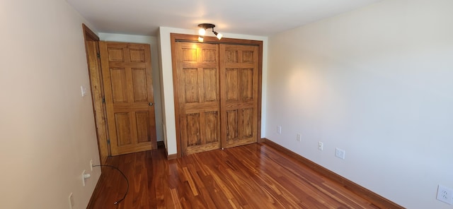 162 30th St, Shapleigh, ME 04076 - unfurnished bedroom with dark wood-style flooring and a closet