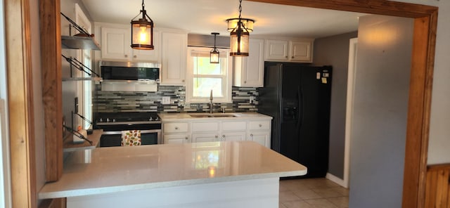 162 30th St, Shapleigh, ME 04076 - kitchen featuring appliances with stainless steel finishes, light tile patterned floors, tasteful backsplash, light countertops, and a peninsula