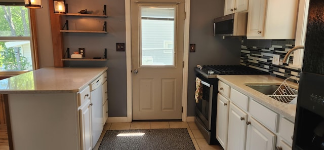 162 30th St, Shapleigh, ME 04076 - kitchen with appliances with stainless steel finishes, open shelves, tasteful backsplash, light tile patterned floors, and white cabinets