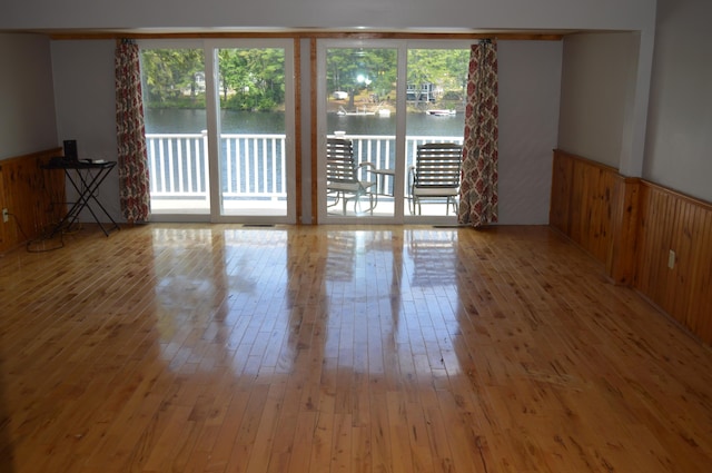 162 30th St, Shapleigh, ME 04076 - spare room featuring hardwood / wood-style flooring, a wainscoted wall, a water view, and wood walls