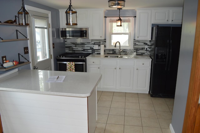 162 30th St, Shapleigh, ME 04076 - kitchen with stainless steel appliances, backsplash, light tile patterned flooring, and white cabinets