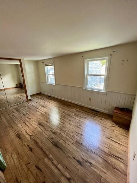 162 30th St, Shapleigh, ME 04076 - unfurnished bedroom featuring wood-type flooring and a wainscoted wall