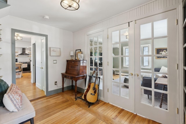 239 Auburn St, Portland, ME 04103 - living area featuring french doors, light wood-type flooring, and baseboards