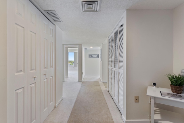 31 E Grand Ave Unit 80, Old Orchard Beach, ME 04064 - corridor featuring light carpet, baseboards, and a textured ceiling