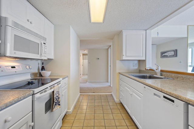31 E Grand Ave Unit 80, Old Orchard Beach, ME 04064 - kitchen with white appliances, a sink, light tile patterned flooring, white cabinets, and a textured ceiling