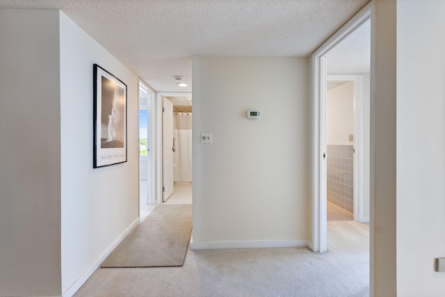 31 E Grand Ave Unit 80, Old Orchard Beach, ME 04064 - corridor with light carpet, a textured ceiling, and baseboards