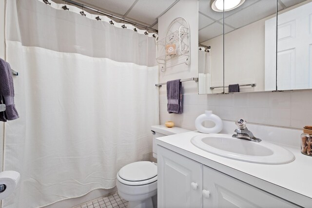 31 E Grand Ave Unit 80, Old Orchard Beach, ME 04064 - bathroom featuring vanity, tasteful backsplash, toilet, a shower with shower curtain, and a drop ceiling