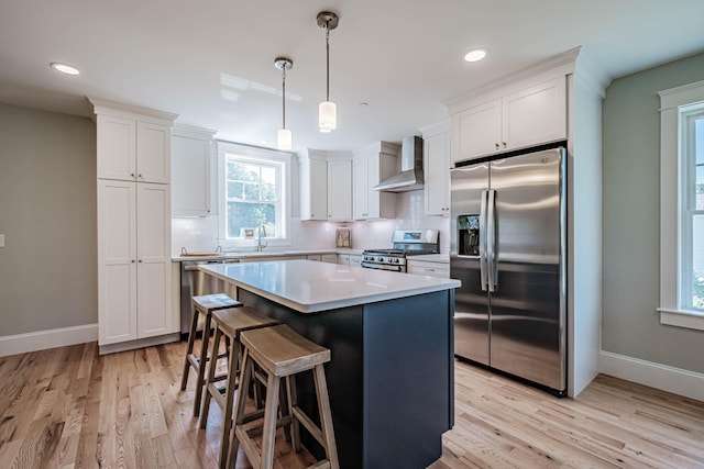 186 Falcon Crest Dr Unit 57, Gorham, ME 04038 - kitchen with stainless steel appliances, wall chimney range hood, tasteful backsplash, baseboards, and recessed lighting