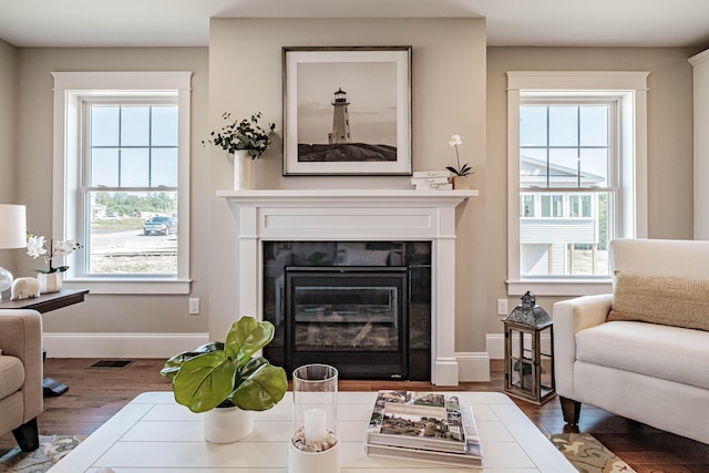 186 Falcon Crest Dr Unit 57, Gorham, ME 04038 - living area with wood finished floors, a tiled fireplace, and baseboards