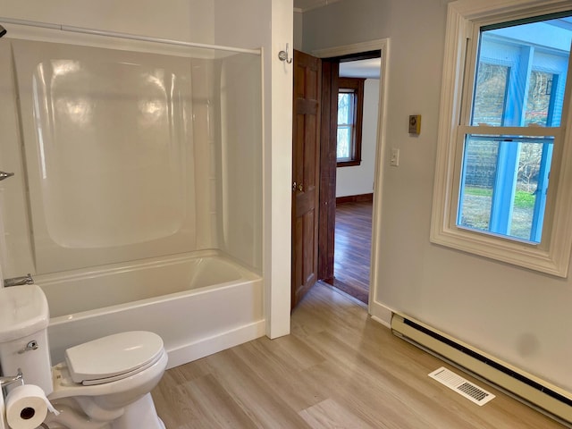 48 River Rd, Buxton, ME 04093 - full bath featuring toilet, wood finished floors, shower / washtub combination, baseboards, and baseboard heating