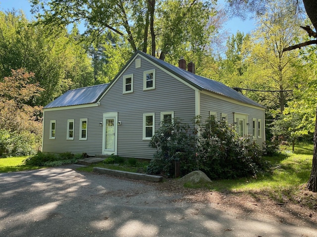 48 River Rd, Buxton, ME 04093 - view of front of property with metal roof and a chimney