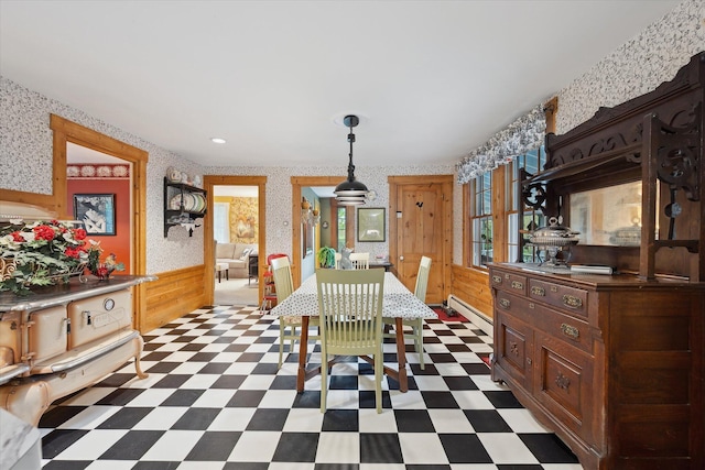 62 Blackswoods Rd, Franklin, ME 04634 - dining room featuring a baseboard heating unit, tile patterned floors, wallpapered walls, and wooden walls