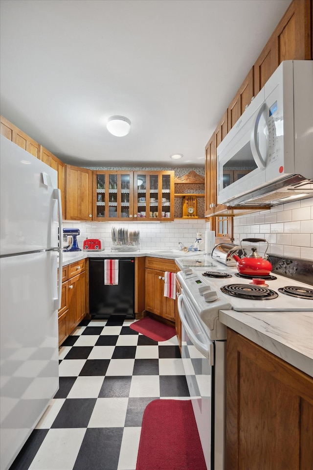 62 Blackswoods Rd, Franklin, ME 04634 - kitchen featuring white appliances, dark flooring, light countertops, and backsplash