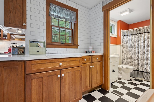 62 Blackswoods Rd, Franklin, ME 04634 - bathroom featuring tile patterned floors, vanity, toilet, and backsplash