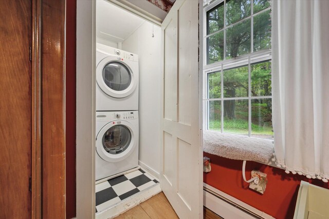 62 Blackswoods Rd, Franklin, ME 04634 - laundry area featuring stacked washer / dryer, light floors, healthy amount of natural light, and a baseboard heating unit