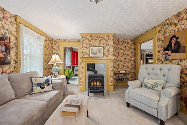 62 Blackswoods Rd, Franklin, ME 04634 - living room with a wood stove, carpet, wallpapered walls, and a textured ceiling