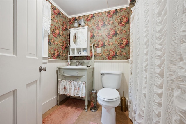 62 Blackswoods Rd, Franklin, ME 04634 - bathroom featuring wallpapered walls, vanity, a wainscoted wall, toilet, and crown molding