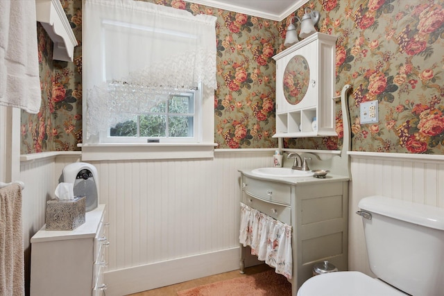 62 Blackswoods Rd, Franklin, ME 04634 - bathroom with wallpapered walls, a wainscoted wall, vanity, and toilet