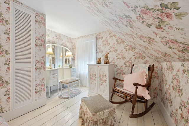 62 Blackswoods Rd, Franklin, ME 04634 - sitting room with wallpapered walls, wood-type flooring, and vaulted ceiling