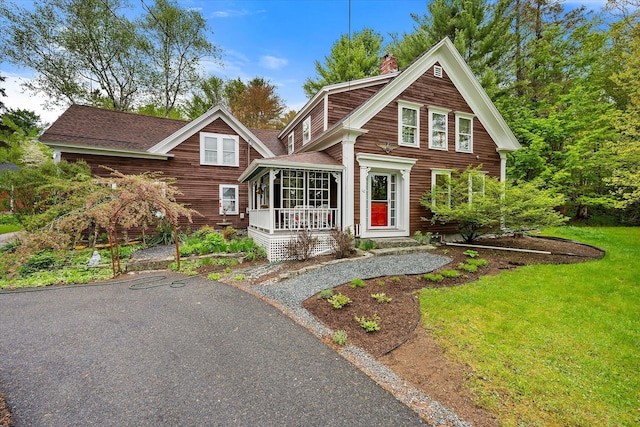 62 Blackswoods Rd, Franklin, ME 04634 - view of front of home featuring a chimney, a shingled roof, a front yard, and covered porch
