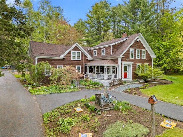 62 Blackswoods Rd, Franklin, ME 04634 - view of front of property with covered porch, a chimney, and roof with shingles