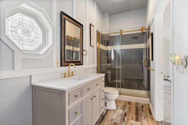 4 Buttonwood Rd, South Berwick, ME 03908 - bathroom with toilet, vanity, a shower stall, wood finished floors, and a baseboard heating unit