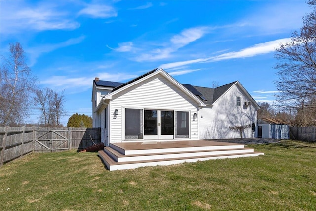 4 Buttonwood Rd, South Berwick, ME 03908 - back of house with a wooden deck, french doors, a chimney, roof mounted solar panels, and a gate