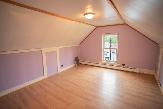 28 Pier St, Bangor, ME 04401 - bonus room featuring baseboard heating, light wood-style flooring, vaulted ceiling, and baseboards