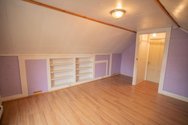 28 Pier St, Bangor, ME 04401 - additional living space featuring light wood-type flooring, vaulted ceiling, built in features, a baseboard radiator, and baseboards