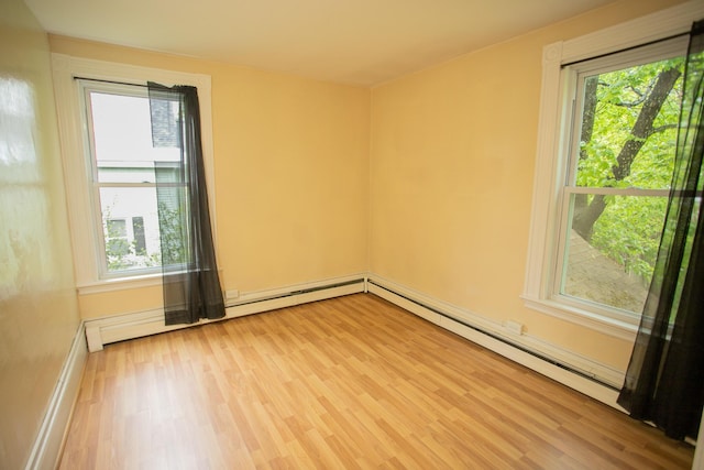 28 Pier St, Bangor, ME 04401 - empty room with light wood-style floors and baseboard heating