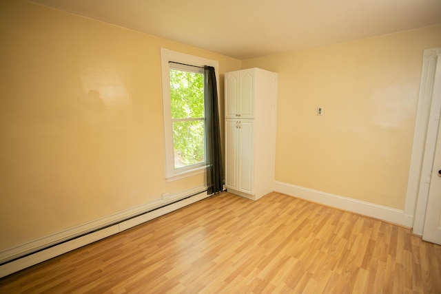28 Pier St, Bangor, ME 04401 - spare room with a baseboard heating unit, light wood-style flooring, and baseboards