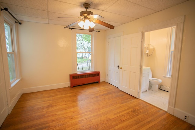 28 Pier St, Bangor, ME 04401 - unfurnished bedroom featuring radiator, a baseboard radiator, light wood-style flooring, baseboards, and ensuite bath