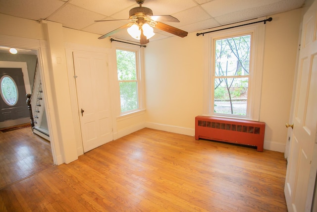 28 Pier St, Bangor, ME 04401 - unfurnished room featuring radiator, a drop ceiling, light wood finished floors, a ceiling fan, and baseboards