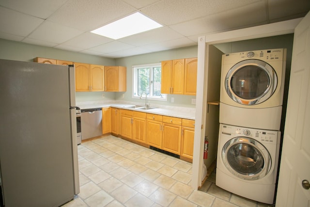 28 Pier St, Bangor, ME 04401 - laundry area featuring a sink, estacked washer and dryer, and light tile patterned floors