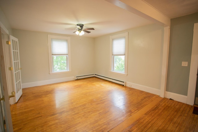 28 Pier St, Bangor, ME 04401 - empty room with plenty of natural light, wood-type flooring, a ceiling fan, and a baseboard radiator