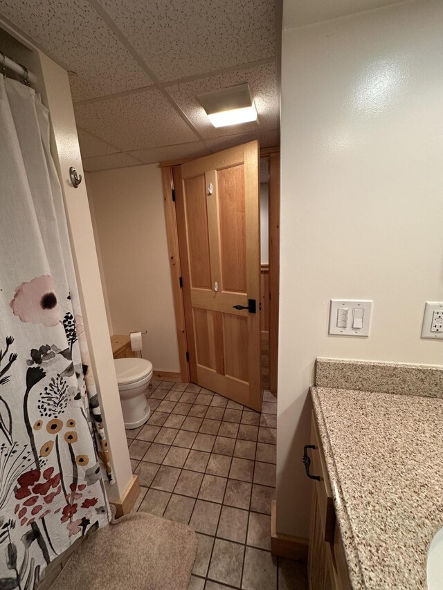 7 Ponderosa Ln, Biddeford, ME 04005 - bathroom with toilet, vanity, tile patterned floors, a drop ceiling, and a shower with curtain